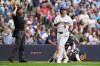 Milwaukee Brewers' Jake Bauers flips his bat after hitting a two-run home run during the third inning of a baseball game against the Atlanta Braves, Saturday, Aug. 22, 2026, in Milwaukee. (AP Photo/Aaron Gash)