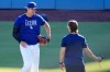 Los Angeles Dodgers' Shohei Ohtani warms up with a trainer prior to a baseball game against the Pittsburgh Pirates, Friday, Aug. 21, 2026, in Los Angeles. (AP Photo/Mark J. Terrill)