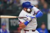 Texas Rangers' Jake Burger is hit by a pitch during the third inning of a baseball game against the Los Angeles Angels, Saturday, Aug. 22, 2026, in Arlington, Texas. (AP Photo/LM Otero)