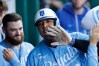 Kansas City Royals' Salvador Perez, center, celebrates in the dugout after hitting a home run as Kyle Isbel stands behind during the fourth inning of a baseball game in Kansas City, Mo., Saturday, Aug. 22, 2026. (AP Photo/Colin E. Braley)