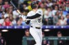 Colorado Rockies' Mickey Moniak watches his solo home run off Cleveland Guardians starting pitcher Tanner Bibee in the fifth inning of a baseball game Saturday, Aug. 22, 2026, in Denver. (AP Photo/David Zalubowski)