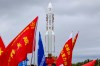 In this photo released by Xinhua News Agency, the combination of the Chang'e-7 lunar probe and the Long March-5 Y14 carrier rocket is transferred vertically to the launching area at the Wenchang Spacecraft Launch Site in southern China's Hainan Province on Wednesday, Aug. 19, 2026 . (Yang GuanyuXinhua via AP)