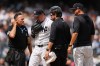 New York Yankees manager Aaron Boone, right, and home plate umpire Dan Iassogna, left, watch as pitcher Ryan Weathers leaves during the fourth inning of a baseball game against the Toronto Blue Jays Saturday, Aug. 22, 2026, in New York. (AP Photo/Frank Franklin II)