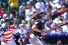 Cleveland Guardians' Chase DeLauter, right, watches his RBI triple with Colorado Rockies catcher Brett Sullivan, left, in the first inning of a baseball game Sunday, Aug. 23, 2026, in Denver. (AP Photo/David Zalubowski)