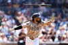 San Diego Padres' Fernando Tatis Jr. tosses his bat after hitting a two-RBI single against the Minnesota Twins in the sixth inning of a baseball game Sunday, Aug. 23, 2026, in San Diego. (AP Photo/Derrick Tuskan)
