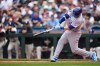 Chicago Cubs' Ian Happ hits a grand slam against the Seattle Mariners during the third inning of a baseball game, Sunday, Aug. 23, 2026, in Seattle. (AP Photo/Lindsey Wasson)