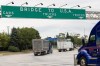 Transport trucks cross the Ambassador Bridge into the United States of America, in Windsor, Ont., Saturday, Aug. 22, 2026. THE CANADIAN PRESS/Dax Melmer
