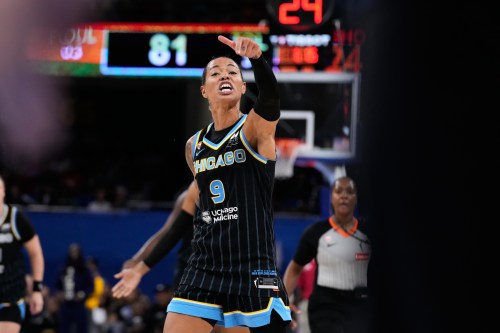Chicago Sky guard Natasha Cloud argues with former NBA center Enes Kanter Freedom, right, during the second half of a WNBA basketball game against the Indiana Fever, Sunday, Aug. 23, 2026, in Chicago. (AP Photo/Nam Y. Huh)