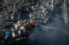 Palestinians try to extinguish a fire in the rubble of a destroyed building following an Israeli airstrike in Gaza City, Monday, Aug. 24, 2026. (AP Photo/Jehad Alshrafi)