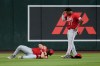 An injured Cincinnati Reds left fielder Michael Toglia (48) holds his shoulder as Reds center fielder Dane Myers (17) looks on during the first inning of a baseball game against the Arizona Diamondbacks, Friday, Aug. 21, 2026, in Phoenix. (AP Photo/Ross D. Franklin)