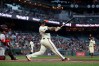 San Francisco Giants' Rafael Devers, right, watches his three-run home run in front of Cincinnati Reds catcher Jose Trevino, left, during the second inning of a baseball game in San Francisco, Monday, Aug. 24, 2026. (AP Photo/Jed Jacobsohn)