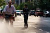 A person rides on an electric scooter in Toronto, on Tuesday, Aug. 11, 2026. THE CANADIAN PRESS/Keito Newman