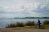 A cyclist talks on the phone as they look out at Lake Ontario from Tommy Thompson Park in Toronto, on Tuesday, Aug. 25, 2026. THE CANADIAN PRESS/Keito Newman