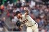 San Francisco Giants pitcher Carson Whisenhunt throws against the Cincinnati Reds during the first inning of a baseball game in San Francisco, Monday, Aug. 24, 2026. (AP Photo/Jed Jacobsohn)