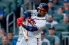 Atlanta Braves' Ozzie Albies (1) hits an RBI sacrifice fly against the Los Angeles Dodgers during the first inning of a baseball game, Tuesday, Aug. 25, 2026, in Atlanta. (AP Photo/Erik S. Lesser)