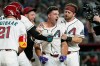 Arizona Diamondbacks' Ryan Waldschmidt, center, celebrates his walk-off, two-run home run against the Chicago Cubs with Diamondbacks' Lars Nootbaar (21), Merrill Kelly and Tim Tawa, right, after a baseball game, Tuesday, Aug. 25, 2026, in Phoenix. (AP Photo/Ross D. Franklin)