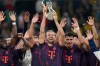 Bayern's Harry Kane holds the trophy after winning the Franz Beckenbauer German Supercup soccer match between Borussia Dortmund and Bayern Munich in Dortmund, Germany, Saturday, Aug. 22, 2026. (AP Photo/Martin Meissner)