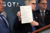 FILE - Hennepin County attorney Mary Moriarty holds up a document containing charges against ICE agent Christian Castro during a news conference at the Hennepin County Government Center in Minneapolis, on Monday, May 18, 2026. (Renée Jones Schneider/Minnesota Star Tribune via AP,File)