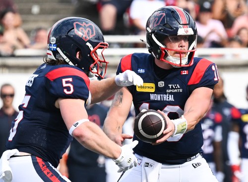 Montreal Alouettes quarterback Davis Alexander (10) hands off to Travis Theis (5) during second half CFL football action against the Edmonton Elks in Montreal, on Saturday, August 8, 2026. THE CANADIAN PRESS/Graham Hughes