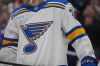 The St. Louis Blues logo is shown on a player's sweater during an NHL hockey game in Denver on Dec. 31, 2025. (AP Photo/David Zalubowski)