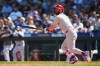 Philadelphia Phillies' Bryce Harper follows through on a double during the fifth inning of a baseball game against the Seattle Mariners, Wednesday, Aug. 26, 2026, in Seattle. (AP Photo/Lindsey Wasson)