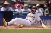 San Diego Padres' Jackson Merrill slides in to score from second base off an RBI single by Luis Rengifo during the second inning of a baseball game against the Pittsburgh Pirates Wednesday, Aug. 26, 2026, in San Diego. (AP Photo/Gregory Bull)
