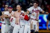 Atlanta Braves pinch-hitter Ha-Seong Kim, center, is mobbed by teammates Victor Mederos, left, and Mauricio Dubón, right, after Kim hit a game-winning RBI single against the Los Angeles Dodgers during the ninth inning of a baseball game, Wednesday, Aug. 26, 2026, in Atlanta. (AP Photo/Erik S. Lesser)