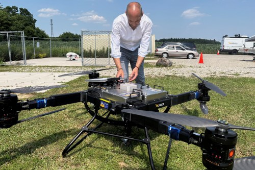 Volatus Aerospace COO Greg Colacitti inspects a heavy lift drone before a test run on July 13, 2026, in Kleinburg, Ontario. (AP Photo/Kelvin Chan)