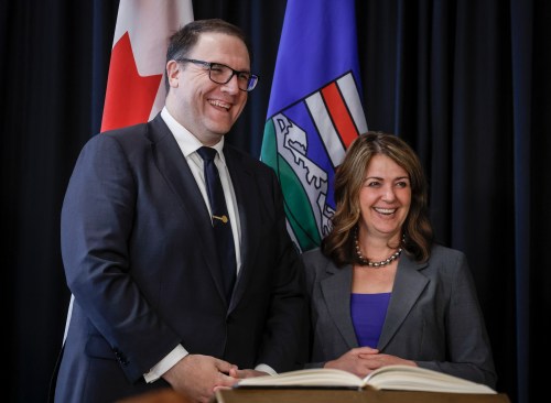 Alberta Premier Danielle Smith, right, stands with new Minister of Assisted Living and Social Services Jason Nixon, following a swearing in ceremony in Calgary, Alta., Friday, May 16, 2025.THE CANADIAN PRESS/Jeff McIntosh