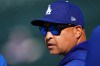 Los Angeles Dodgers manager Dave Roberts looks on as players warm up before a baseball game against the Colorado Rockies, Monday, Aug. 17, 2026, in Denver. (AP Photo/David Zalubowski)