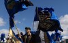 Supporters fly flags in support of Mitch Sylvestre as he submits his signatures for a separation referendum to Elections Alberta in Edmonton, on Monday, May 4, 2026. THE CANADIAN PRESS/Jason Franson