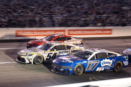 Roush Fenway Keselowski Racing driver Chris Buescher (17) and Joe Gibbs Racing driver Ty Gibbs (54) battle in turn one during Cook Out 400 at Richmond Raceway, Saturday, Aug. 15, 2026, in Richmond Va. (AP Photo/Robert Simmons)