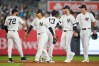 New York Yankees right fielder Spencer Jones, left fielder Cody Bellinger, and center fielder Trent Grisham, right to left, celebrate with teammates after winning a baseball game against the Boston Red Sox, Friday, Aug. 28, 2026, in New York. (AP Photo/Yuki Iwamura)