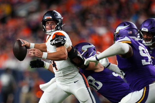 Denver Broncos quarterback Sam Ehlinger (4) throws a pass as he is hit by Minnesota Vikings linebacker Bo Richter (98) during the first half of a preseason NFL football game, Friday, Aug. 28, 2026, in Denver. (AP Photo/Jack Dempsey)