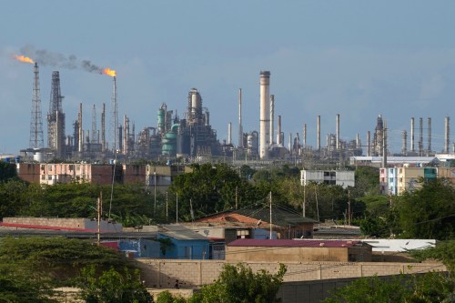 FILE - Flames rise from flare stacks at the Amuay refinery in Los Taques, Venezuela, Jan. 14, 2026. (AP Photo/Matias Delacroix, File)