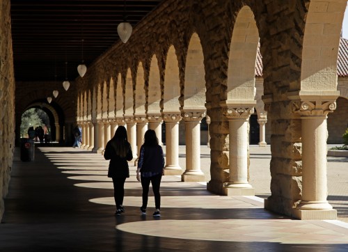 FILE - Students walk through the Stanford University campus, March 14, 2019, in Santa Clara, Calif. (AP Photo/Ben Margot, File)