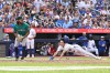 Blue Jays outfielder Brett Bateman, right, scores on a wild pitch against the Seattle Mariners in a Major League Baseball game in Toronto on Aug. 29, 2026. THE CANADIAN PRESS/Jon Blacker