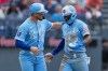 Kansas City Royals' Nick Loftin (12) ad Tyler Tolbert (2) celebrate after both scored on a double by Isaac Collins in the fifth inning of a baseball game in Cleveland, Saturday, Aug. 29, 2026. (AP Photo/Sue Ogrocki)