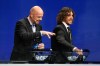 FILE - UEFA General Secretary Gianni Infantino, left, speaks with former Barcelona player Carles Puyol, who prepares the draw, during the UEFA Champions League draw at the Grimaldi Forum in Monaco, Aug. 27, 2015. (AP Photo/Claude Paris, File)