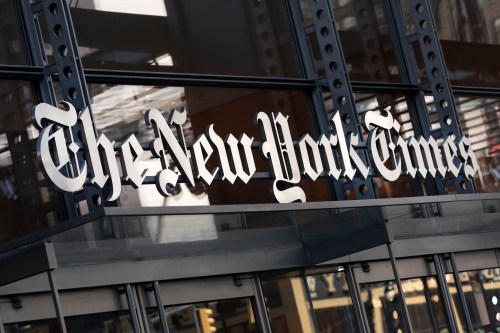FILE - A sign for The New York Times hangs above the entrance to its building in New York, May 6, 2021. (AP Photo/Mark Lennihan, File)