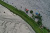 A drone view shows a major section of Pasang Lhamu highway washed away along swollen Trishuli river by recent flash floods cutting off Rasuwa district from Nuwakot area, Nepal, Monday, Aug. 31, 2026. (AP Photo/Rajesh Kumar Singh)