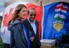 Alberta Premier Danielle Smith, left, waits to deliver a speech on Alberta Day in Calgary, Alta., Sunday, Aug. 30, 2026.THE CANADIAN PRESS/Jeff McIntosh