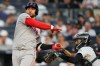 Boston Red Sox Willson Contreras hits New York Yankees catcher Austin Wells in the arm with his bat during the first inning of a baseball game, Friday, Aug. 28, 2026, in New York. (AP Photo/Yuki Iwamura)