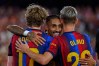 Barcelona's Anthony Gordon celebrates with his teammate Barcelona's Raphinha, center, and Barcelona's Dani Olmo, right, after Rayo's Florian Lejeune scores an own goal during a Spanish La Liga soccer match between Barcelona and Rayo Vallecano in Barcelona, Spain, Monday, Aug. 31, 2026. (AP Photo/Joan Monfort)