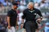 Colorado Rockies manager Warren Schaeffer, left, reacts with home plate umpire Manny Gonzalez, right, who replaced an injured Ron Kulpa in the seventh inning of a baseball game between the Colorado Rockies and the Atlanta Braves, Saturday, Aug. 29, 2026, in Atlanta. (AP Photo/Colin Hubbard)
