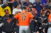 Baltimore Orioles center fielder Colton Cowser is congratulated by teammates after the Orioles' victory over the Colorado Rockies in a baseball game Monday, Aug. 31, 2026, in Denver. (AP Photo/David Zalubowski)