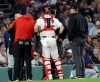 A game delay was called after the home plate umpire, far left, was hit by a pitch during the sixth inning of a baseball game between the Boston Red Sox and Seattle Mariners, Tuesday, Sept. 1, 2026, in Boston. (AP Photo/Mark Stockwell)