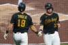 Pittsburgh Pirates' Henry Davis, right, and Jared Triolo (19) celebrate after scoring on a single by Spencer Horwitz off San Francisco Giants pitcher Braxton Roxby during the third inning of a baseball game in Pittsburgh, Tuesday, Sept. 1, 2026. (AP Photo/Gene J. Puskar)