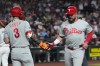 Philadelphia Phillies' Kyle Schwarber, right, celebrates his run scored against the Arizona Diamondbacks with Phillies' Bryce Harper (3) during the first inning of a baseball game, Tuesday, Sept. 1, 2026, in Phoenix. (AP Photo/Ross D. Franklin)