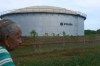 A woman walks near of a oil storage tank of Venezuela's state-run oil company, PDVSA in Cabimas, Venezuela, Tuesday, Sep. 1, 2026. (AP Photo/Ariana Cubillos)